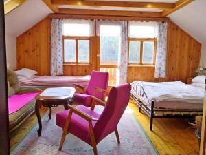 sypialnia z fioletowymi krzesłami, łóżkami i oknami w obiekcie Chalupa Branžež Komárovský rybník w mieście Branžež