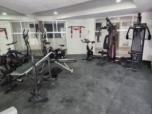 a gym with several treadmills and exercise bikes at Amplio departamento con alberca in Guadalajara