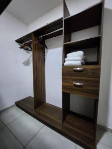 baño con armario de madera y toallas. en Amplio departamento con alberca, en Guadalajara
