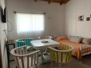 a room with a bed and a table and chairs at Departamento MPM 2 in Mercedes