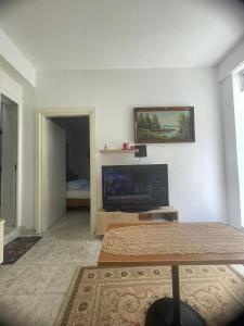 a living room with a flat screen tv on a wall at Flat in Tirana