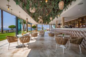 a restaurant with tables and chairs and a bar at Hotel Torre del Mar - Ibiza in Playa d'en Bossa