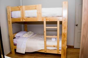 a couple of bunk beds in a room at Bungalows Payancas de Tato in Barranca