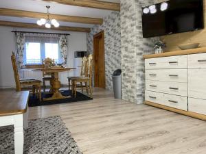 a living room with a tv on a brick wall at VILLA MARTINI in Lazy pod Makytou