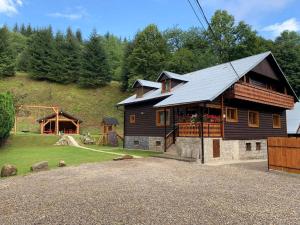 a house with a metal roof on top of it at VILLA MARTINI in Lazy pod Makytou