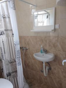 a bathroom with a sink and a mirror at Mica apartmani in Sutomore