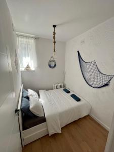 a small bedroom with a bed and a window at Sailor Apartment by Marina Old Town for 8 people, free parking! in Gdańsk