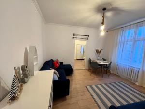 a living room with a couch and a table at Sailor Apartment by Marina Old Town for 8 people, free parking! in Gdańsk