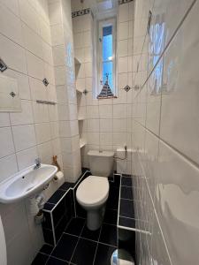 a small bathroom with a toilet and a sink at Sailor Apartment by Marina Old Town for 8 people, free parking! in Gdańsk