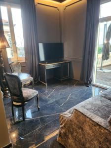 a bedroom with a desk and a chair and a table at Hotel Zia Piera in Chiavari