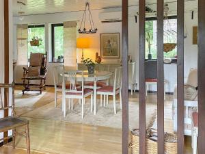 a dining room with a table and chairs at Holiday home KIL II in Kil