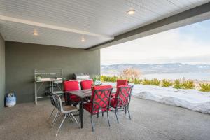 a table and chairs in a room with a view at Cozy one bedroom with private bathroom in Kelowna in Kelowna