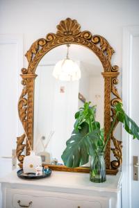 an ornate mirror on top of a dresser at Résidence méditerranée - Beachfront - Sun and Seaview - Pool - Private Parking in Cagnes-sur-Mer +16 photos