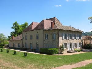 a large brick building with a roof at Les Douglas in Matour