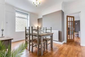 a dining room with a table and chairs at Victorian Terrace, East Ardsley in Robin Hood