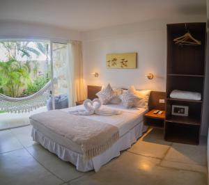 a bedroom with a bed and a large window at Libert Hotel in Porlamar