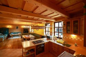 a kitchen and living room with a stove top oven at Chalupa Beliankovo in Ždiar