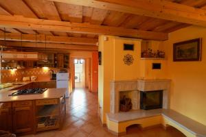 a kitchen with a fireplace in the middle of it at Chalupa Beliankovo in Ždiar