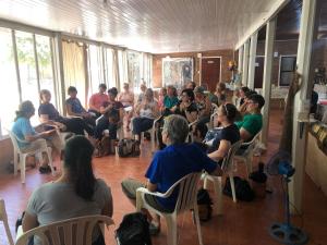 a group of people sitting in chairs in a room at Hotel Campestre Iparoma in Estancia Campo Aroma