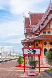a building with a sign in front of a train station at GO INN HuaHin โกอินน์ หัวหิน in Hua Hin