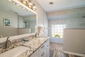 ein Badezimmer mit zwei Waschbecken und einem großen Spiegel in der Unterkunft Litchfield Country Club Cottage 4BR 4BA Retreat in Pawleys Island + 12 Fotos