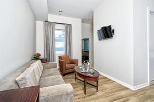 a living room with a couch and a table at Hotel Griffon in San Francisco