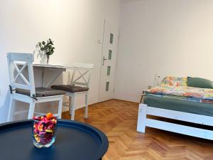 a room with a table and a bed and a desk at Apartmán Pod Vyhlídkou in Nové Město nad Metují +8 photos