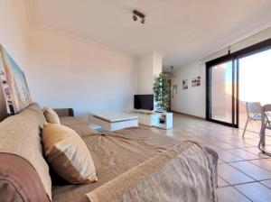 a living room with a couch and a tv at Sunny Home La Tejita in Granadilla de Abona