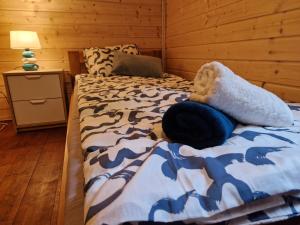 um quarto com uma cama num quarto de madeira em Przystań Zakapiora 