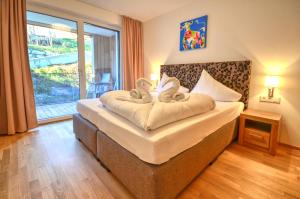 a hotel room with a bed with towels on it at Alpin & Seeresort Top 10 - by Alpen Apartments in Zell am See