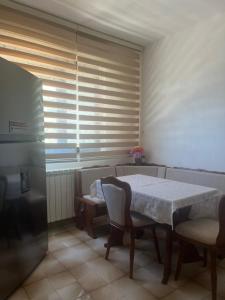 comedor con mesa, sillas y ventana en Apartment Salaj, en Ulcinj