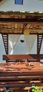 a wooden bench under a wooden table with a picnic at Vareš in Vareš