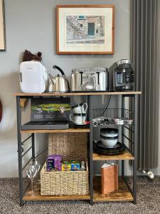 a shelf with food and items on it at Priest Royd Nook - Luxury Lodgings 