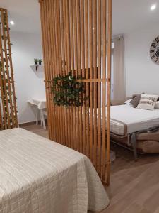 1 dormitorio con cama y tabique de madera en Vive el Renacimiento: Cazuela, en Baeza