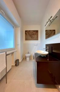 a bathroom with a sink and a toilet at NUMERONOVE Sirolo in Sirolo