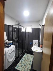 a bathroom with two toilets and a sink and a shower at Hostel Raft Neretva in Konjic