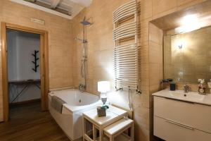 a bathroom with a tub and a sink at Castel Sant'Angelo Apartments - Exclusive & Luxury in Rome +27 photos