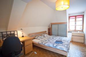 a bedroom with a bed and a desk and a chair at Center Rynek in Wrocław