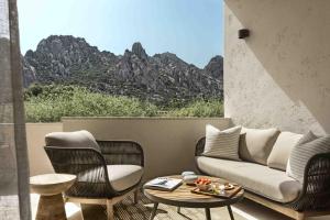 a living room with a couch and chairs and a table at Borgo Antico San Pantaleo in San Pantaleo