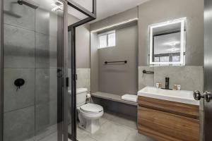 a bathroom with a toilet and a sink and a mirror at Singular Goldsmith in Mexico City +90 photos