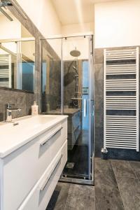 a bathroom with a white sink and a shower at B&B La Loggia Del Castello in Trento