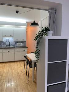 a kitchen with a table and a dining room at Le Central Limoilou "parking inclus" in Quebec City