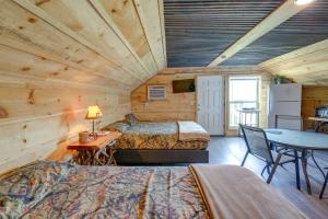 a bedroom with two beds and a table in a room at Cozy Huntsville Escape with Brimstone Trail Access! in Huntsville