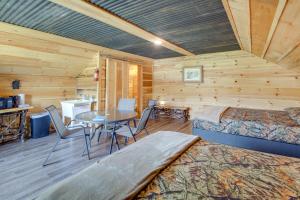 a cabin with two beds and a table in a room at Cozy Huntsville Escape with Brimstone Trail Access! in Huntsville