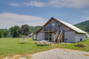 a barn with picnic tables in front of it at Cozy Huntsville Escape with Brimstone Trail Access! in Huntsville