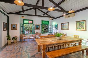 a dining room with a wooden table and chairs at Abaporu Art Hostel in Florianópolis