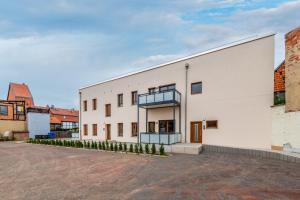 um grande edifício branco com uma varanda em Modernes Apartment, Altstadt, Parkplatz, NETFLIX em Quedlinburg