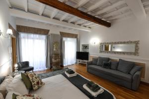 a living room with a couch and a tv at Castel Sant'Angelo Apartments - Exclusive & Luxury in Rome