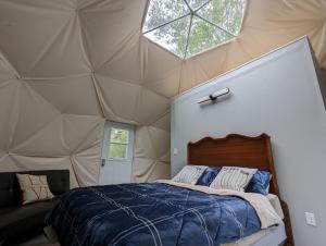a bedroom with a bed in a tent at Fundy Spray Campground in Smiths Cove