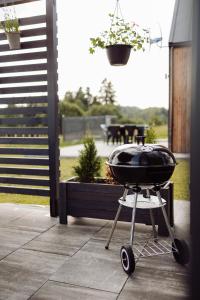 a barbecue grill sitting on a patio with a table at Osada Przejrzysko in Jordanów +45 photos